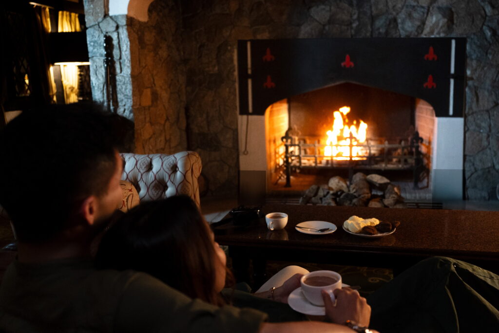 A Couple Enjoying Fireplace at Lakehouse Cameron